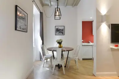 a dining room with a table and chairs at EVE Luxury Apartments Pantheon in Rome
