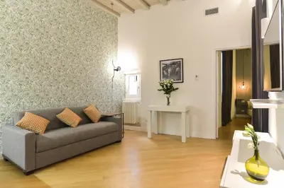 a living room with a couch and a table at EVE Luxury Apartments Pantheon in Rome