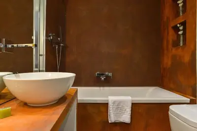 a bathroom with a large bowl sink and a tub at EVE Luxury Apartments Pantheon in Rome