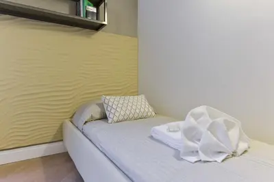 a white couch with a pillow and a blanket at EVE Luxury Apartments Pantheon in Rome