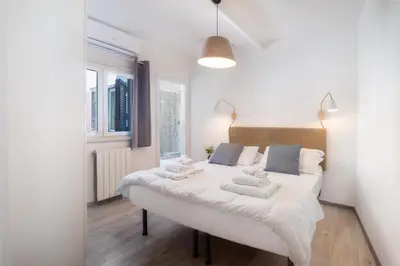 a large white bed in a room with windows at Laura Roof Terrace Teatro dell'Opera in Rome