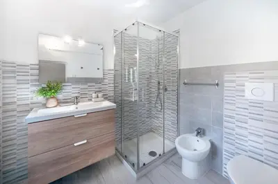 a bathroom with a shower and a sink and a toilet at Laura Roof Terrace Teatro dell'Opera in Rome