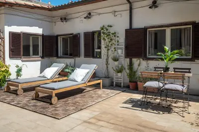 a patio with two chairs and a table at Laura Roof Terrace Teatro dell'Opera in Rome