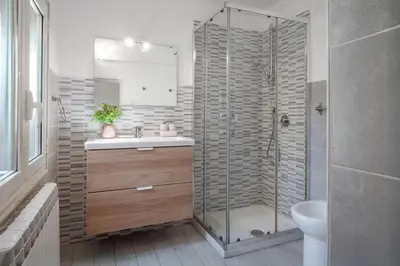 a bathroom with a shower and a sink and a toilet at Laura Roof Terrace Teatro dell'Opera in Rome