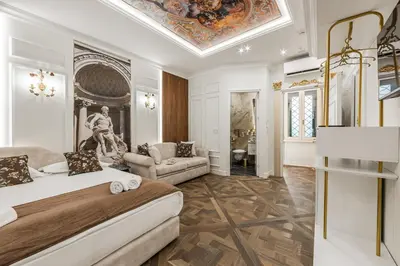 a bedroom with a large bed and a living room at La Bella Trevi in Rome