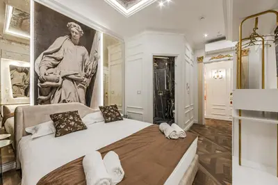 a bedroom with a large painting on the wall at La Bella Trevi in Rome