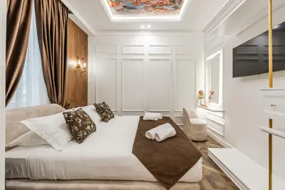 a bedroom with a large white bed with pillows at La Bella Trevi in Rome
