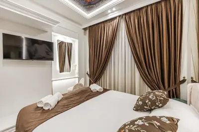 a bedroom with a large bed with two towels at La Bella Trevi in Rome