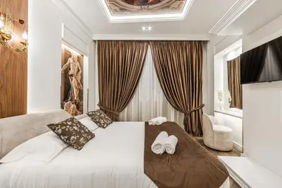 a bedroom with a white bed and a large window at La Bella Trevi in Rome