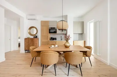 a kitchen and dining room with a wooden table and chairs at 3 bedroom superior apartment Trastevere in Rome