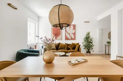 a living room with a table and a couch at 3 bedroom superior apartment Trastevere in Rome