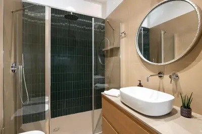 a bathroom with a sink and a shower with a mirror at 3 bedroom superior apartment Trastevere in Rome