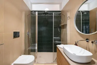 a bathroom with a toilet and a sink and a shower at 3 bedroom superior apartment Trastevere in Rome
