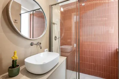 a bathroom with a sink and a shower with a mirror at 3 bedroom superior apartment Trastevere in Rome