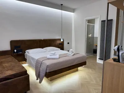 a bedroom with a large bed with towels on it at Ulivo Guest House Roma in Rome