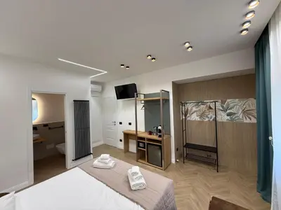 a bedroom with a bed with two towels on it at Ulivo Guest House Roma in Rome