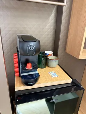 a coffee maker on a table in a refrigerator at Ulivo Guest House Roma in Rome