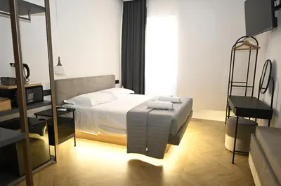 a bedroom with a bed and a chair in it at Ulivo Guest House Roma in Rome