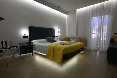 a bedroom with a bed with a yellow blanket at Ulivo Guest House Roma in Rome