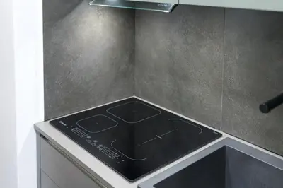 a kitchen with a stove top oven in a kitchen at DOMUS Generale Ezio in Rome