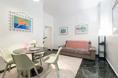 a living room with a table and a couch at DOMUS Generale Ezio in Rome