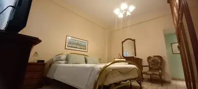 a bedroom with a bed and a mirror and a chair at casawally MetroB Marconi SanPaoloBasilica Colosseo in Rome