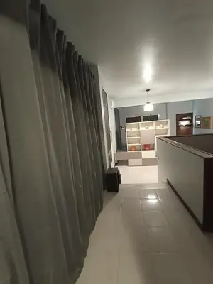 a hallway with curtains in a room with a kitchen at casaemily TrenoFiumicinoAir-VillaBonelli-Ostiense in Rome
