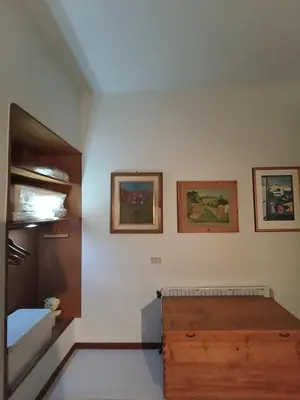 a bedroom with a bed and three pictures on the wall at casaemily TrenoFiumicinoAir-VillaBonelli-Ostiense in Rome