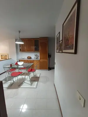 a kitchen and dining room with a table and chairs at casaemily TrenoFiumicinoAir-VillaBonelli-Ostiense in Rome