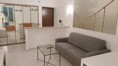 a living room with a couch and a table at Coral Apartment in Rome