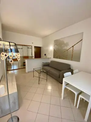 a living room with a couch and a table at Coral Apartment in Rome