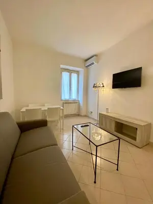 a living room with a couch and a table at Coral Apartment in Rome