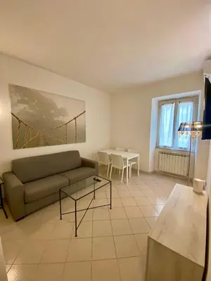 a living room with a couch and a table at Coral Apartment in Rome