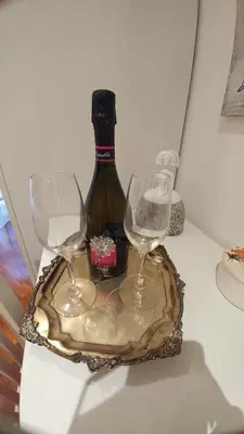two wine glasses and a bottle on a table at Le Scalette Al Vaticano B&B in Rome