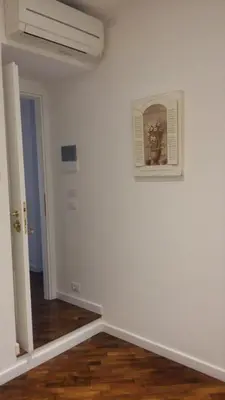 a room with a white wall and a picture on the wall at Le Scalette Al Vaticano B&B in Rome