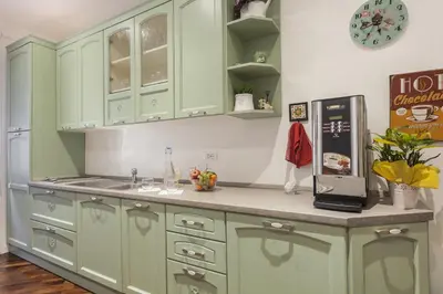 a kitchen with green cabinets and a counter top at Le Scalette Al Vaticano B&B in Rome