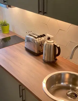 a toaster sitting on a kitchen counter next to a sink at Balduina Boutique Apartment in Rome