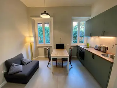 a kitchen with a couch and a table in a kitchen at Balduina Boutique Apartment in Rome