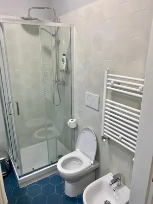 a bathroom with a shower and a toilet and a sink at Balduina Boutique Apartment in Rome