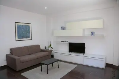 a living room with a couch and a tv at Nice flat near Trastevere Station in Rome
