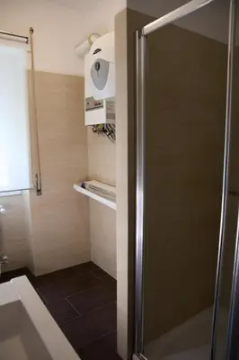 a shower with a glass door in a bathroom at Nice flat near Trastevere Station in Rome
