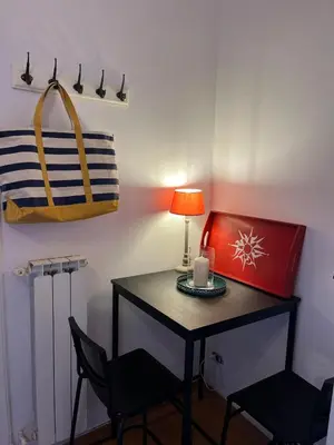 a small table with two chairs and a lamp at Villa Sciarra BnB in Rome