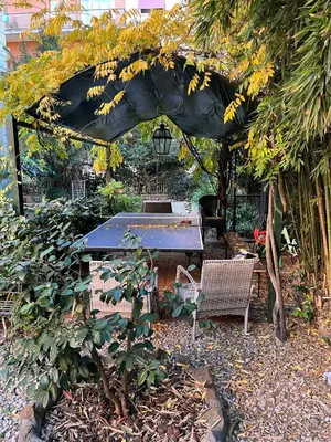 a pergola with a table and chairs in a garden at Villa Sciarra BnB in Rome