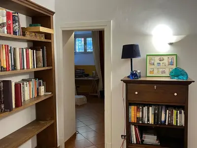 a hallway with book shelves filled with books at Villa Sciarra BnB in Rome