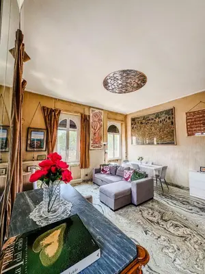 a living room with a couch and a table at Trastevere Tranquility Rome in Rome