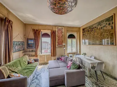 a living room with a couch and a table at Trastevere Tranquility Rome in Rome