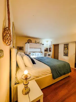 a bedroom with a large bed and a table at Trastevere Tranquility Rome in Rome