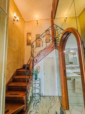 a hallway with a spiral staircase in a home at Trastevere Tranquility Rome in Rome
