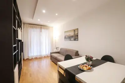 a living room with a couch and a table at Free Parking Chic Home - Balcony, AC, Wi-Fi in Rome