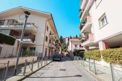 a car parked on a street between two buildings at Free Parking Chic Home - Balcony, AC, Wi-Fi in Rome